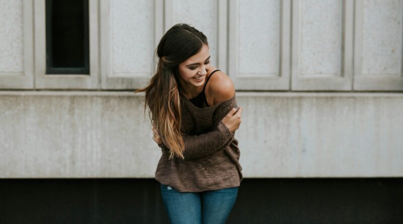 woman standing behind white wall